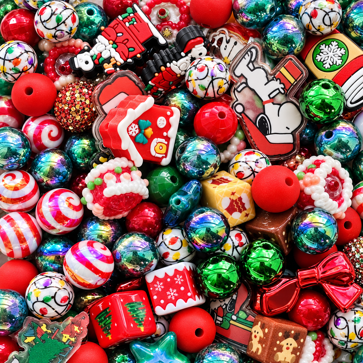 Christmas Mix beads spilling from a clear jar onto a marble surface, showing red and green rounds, peppermint swirls, decorated Christmas houses, gingerbread and holiday character pieces, Christmas-light patterns, sparkling green beads and festive shaped focals.