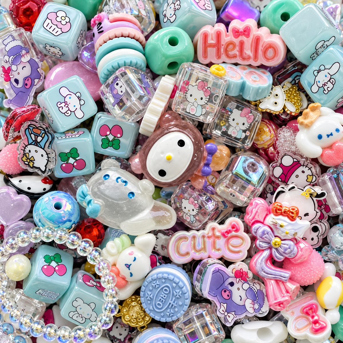 Close-up of JAZ Bead Co. Mega Mix showing pastel printed cubes, character-inspired focal beads, pink word beads, cherry motifs, transparent pieces, novelty shapes and colorful dimensional accents.