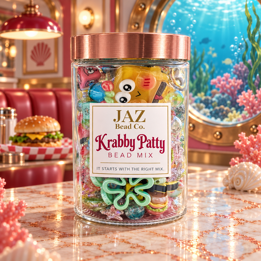 Clear JAZ Bead Co. jar labeled Krabby Patty with a rose-gold lid, filled with colorful burger, character, sea-inspired and novelty beads in pink, yellow, aqua, mint and clear finishes, displayed in a whimsical underwater diner setting.