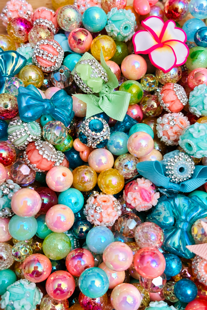 Close-up of Island Princess bead mix with iridescent beads floral accents bows and sparkling details