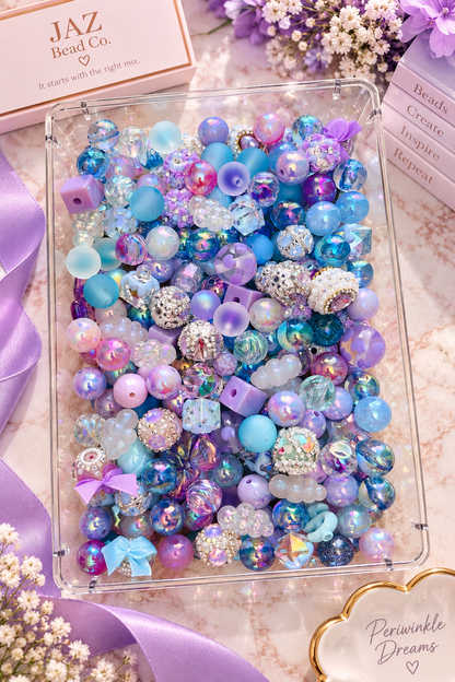 Close-up detail of Periwinkle Dreams bead mix featuring glossy and frosted blue and lavender beads, iridescent finishes, dimensional flowers, crystal-like stars, rhinestone focal beads and pearl accents.