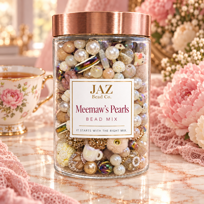 JAZ Bead Co. Memaw’s Pearls bead mix in a clear jar, featuring cream, blush, taupe and pearl beads with floral, gold and iridescent accents in a cozy tea-inspired setting.
